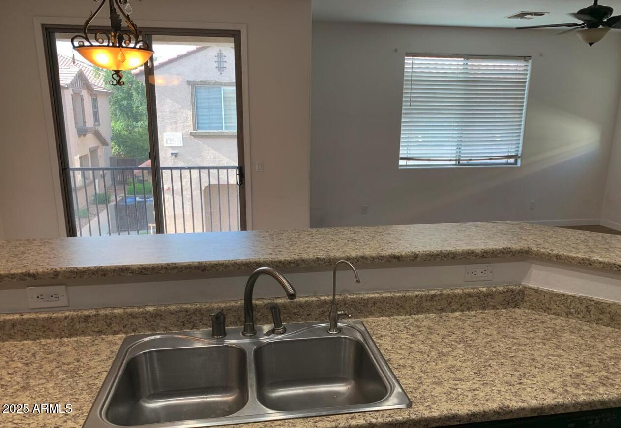 1265 South Aaron, Unit 305 Mesa, AZ 85209 - Photo 11 of 25 a kitchen with a sink and a window