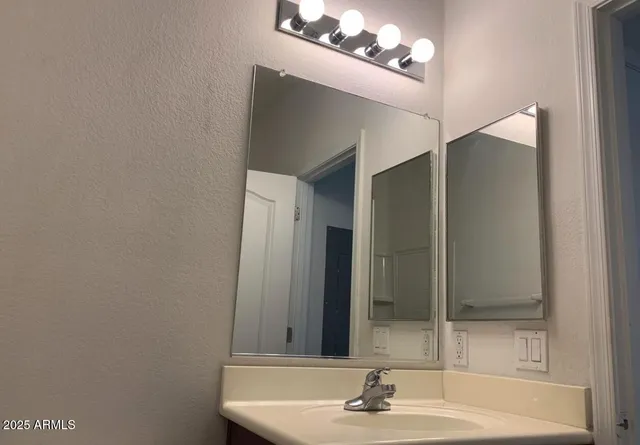 a bathroom with a sink and a mirror