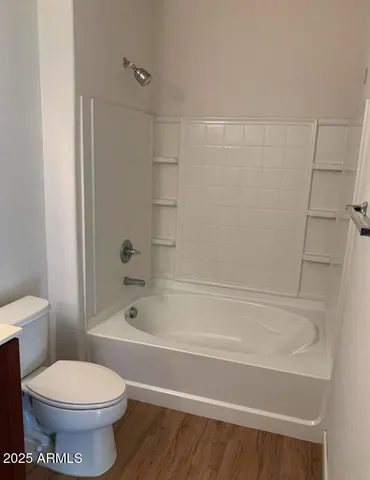 a bathroom with a bathtub and a toilet