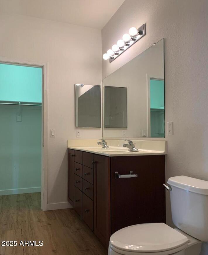 1265 South Aaron, Unit 305 Mesa, AZ 85209 - Photo 17 of 25 a bathroom with a toilet sink and mirror
