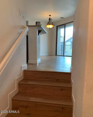 a view of entryway and hall with wooden floor