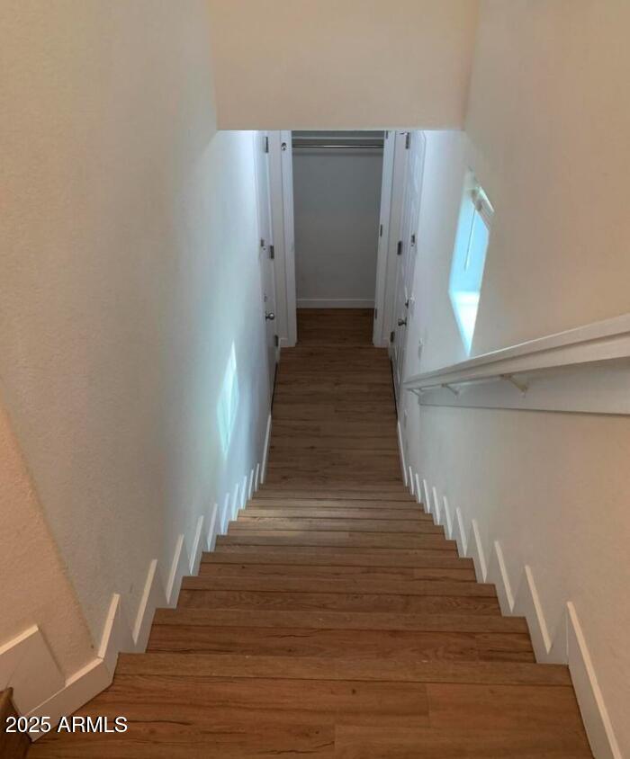 1265 South Aaron, Unit 305 Mesa, AZ 85209 - Photo 20 of 25 a view of a hallway with wooden floor and staircase