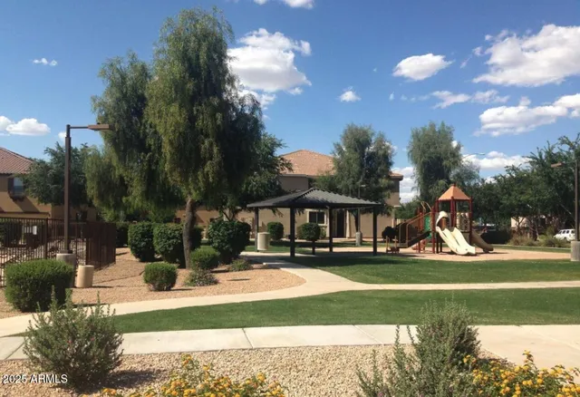 a view of a house with big yard and a fountain