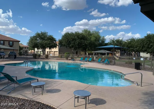 a view of a swimming pool with lounge chairs