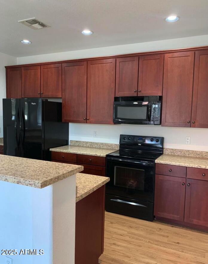 1265 South Aaron, Unit 305 Mesa, AZ 85209 - Photo 5 of 25 a kitchen with stainless steel appliances granite countertop a stove a refrigerator and a microwave