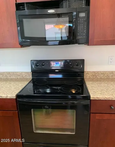 a stove top oven sitting inside of a kitchen