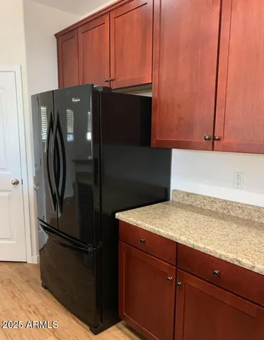 a kitchen with metallic refrigerator freezer and a dishwasher