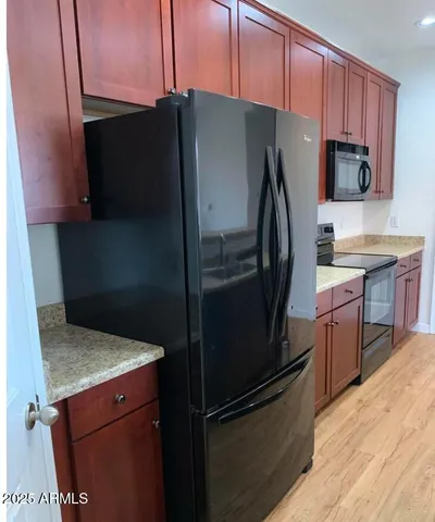 a kitchen with a refrigerator and a sink