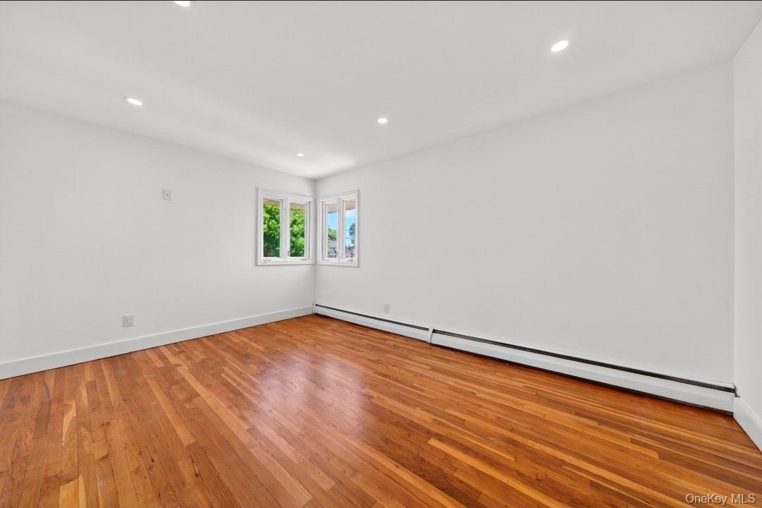 8 White Birch Lane Commack, NY 11725 - Photo 12 of 44 a view of an empty room with wooden floor and a window