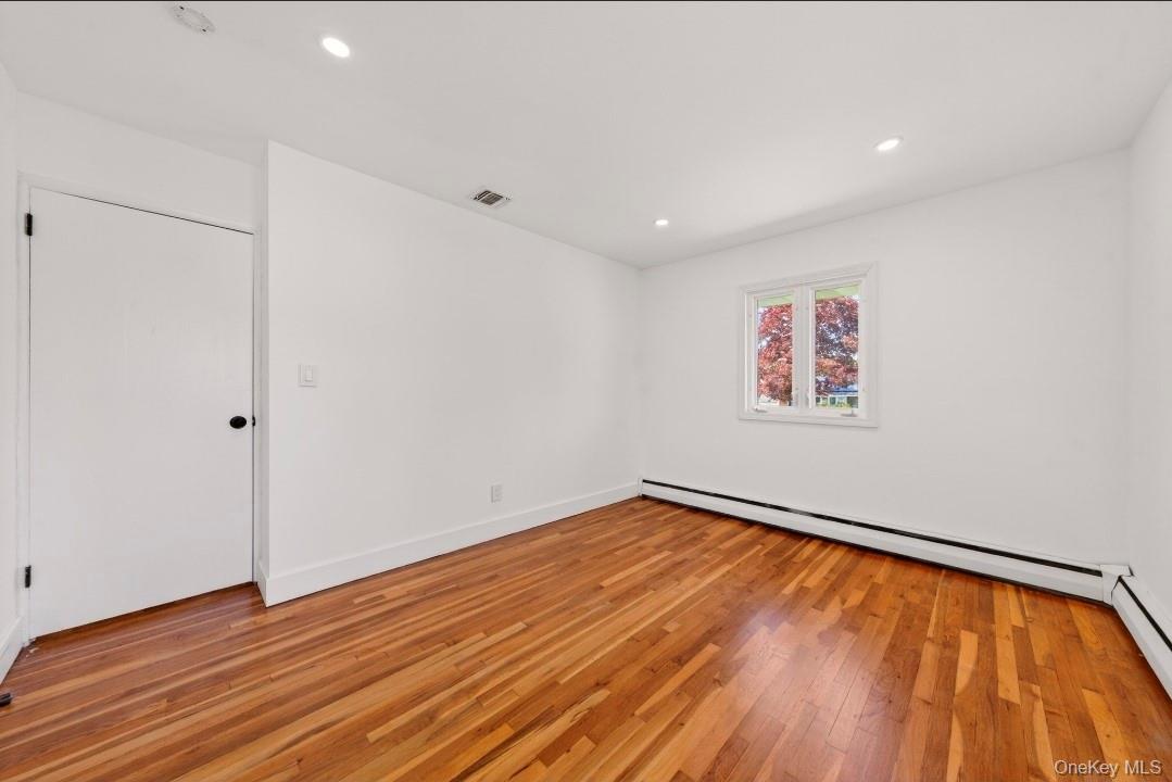 8 White Birch Lane Commack, NY 11725 - Photo 13 of 44 a view of an empty room with wooden floor