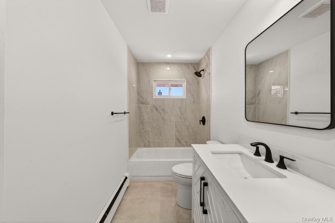 8 White Birch Lane Commack, NY 11725 - Photo 17 of 44 a bathroom with a sink a toilet and shower