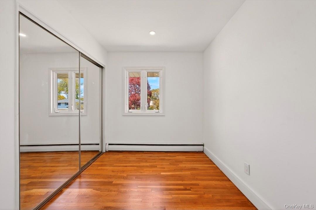 8 White Birch Lane Commack, NY 11725 - Photo 19 of 44 wooden floor in an empty room with a window
