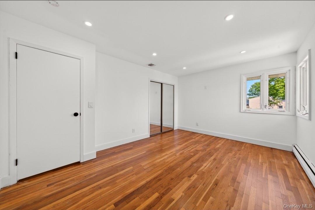 8 White Birch Lane Commack, NY 11725 - Photo 22 of 44 a view of an empty room with wooden floor and a window