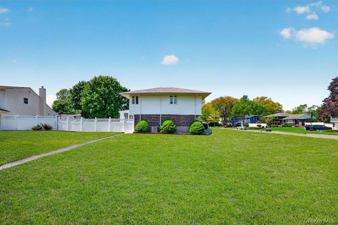 8 White Birch Lane Commack, NY 11725 - Photo 41 of 44 a front view of a house with a yard and garage