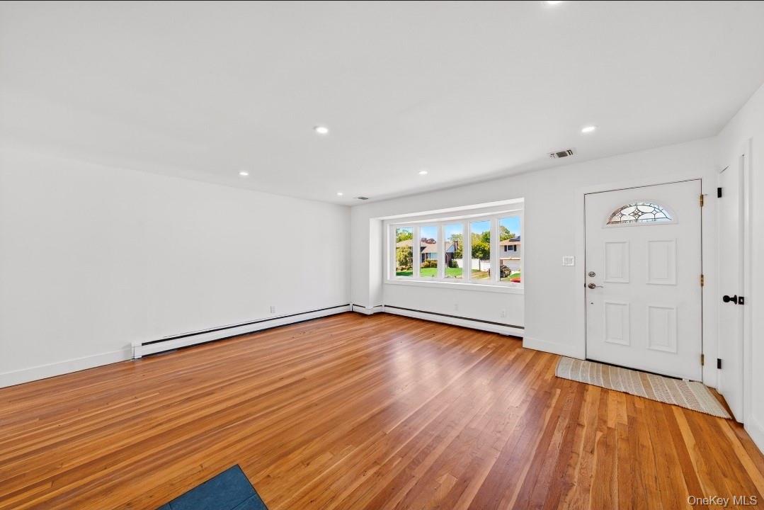 8 White Birch Lane Commack, NY 11725 - Photo 5 of 44 a view of an empty room and wooden floor