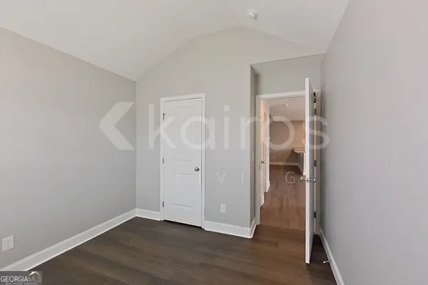 an empty room with wooden floor and closet