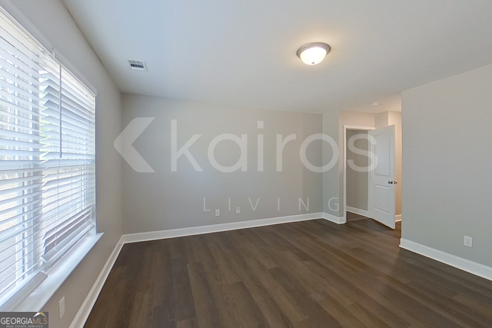 110 Western Red Cedar Drive Springfield, GA 31329 - Photo 12 of 19 a view of an empty room with wooden floor and a window