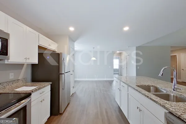 a kitchen with a sink dishwasher a refrigerator and a stove