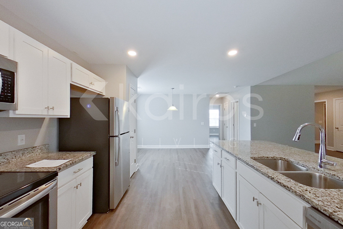 110 Western Red Cedar Drive Springfield, GA 31329 - Photo 6 of 19 a kitchen with a sink dishwasher a refrigerator and a stove