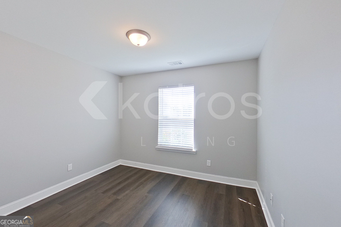 110 Western Red Cedar Drive Springfield, GA 31329 - Photo 8 of 19 an empty room with wooden floor and windows