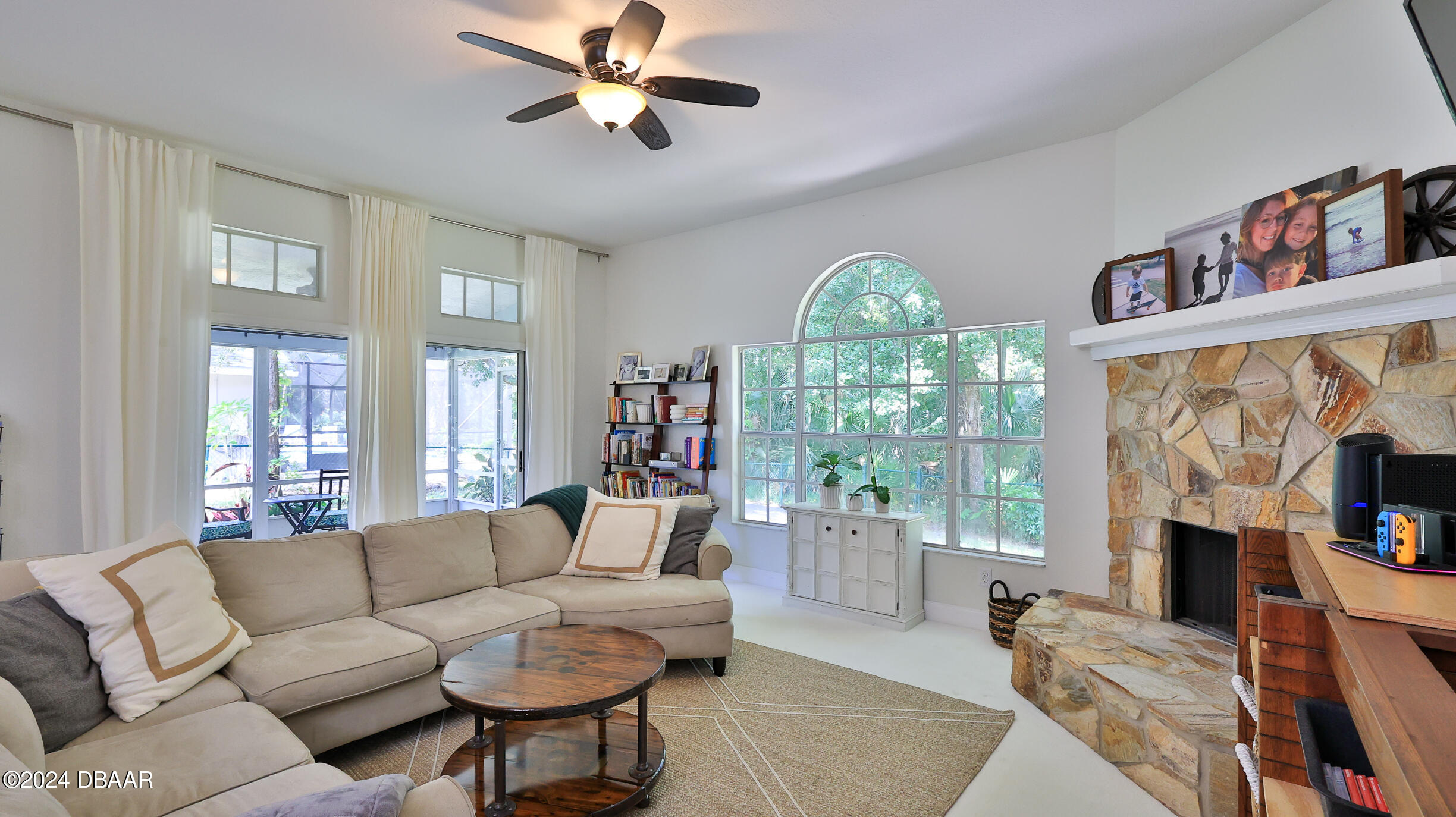 16 Meadow Ridge View Ormond Beach, FL 32174 - Photo 16 of 45 a living room with furniture a fireplace and a large window
