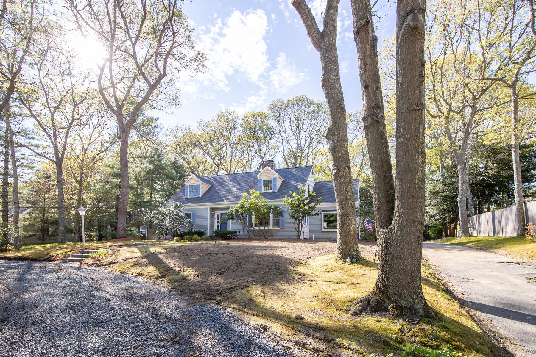 1118 Bumps River Road Centerville, MA 02632 - Photo 2 of 20 a front view of a house with a yard and large trees