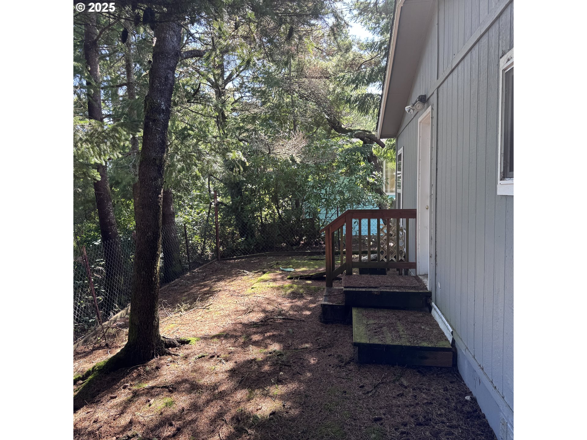 1601 Rhododendron Drive, Unit 695 Florence, OR 97439 - Photo 12 of 42 a view of a porch with a bench in the patio