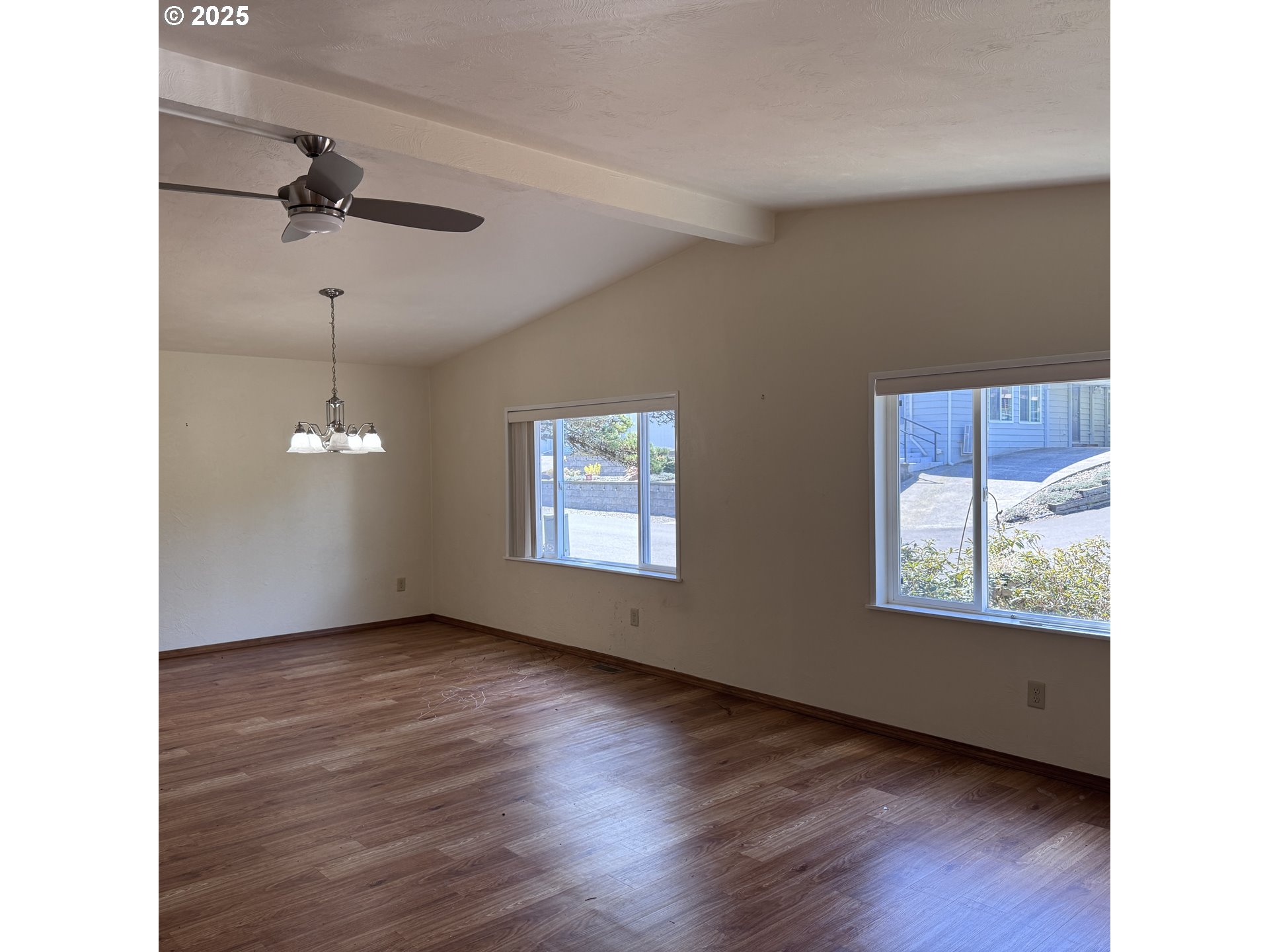 1601 Rhododendron Drive, Unit 695 Florence, OR 97439 - Photo 16 of 42 a view of an empty room with wooden floor and a window
