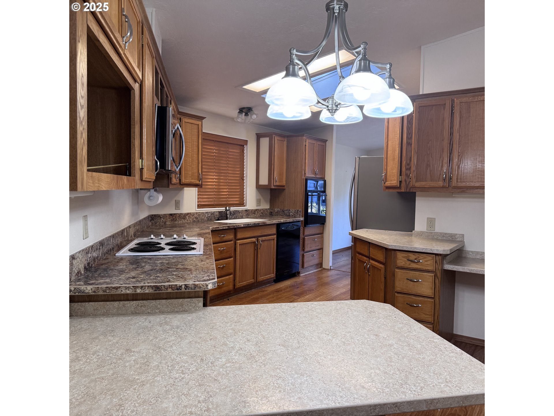 1601 Rhododendron Drive, Unit 695 Florence, OR 97439 - Photo 20 of 42 a kitchen with a stove and a sink