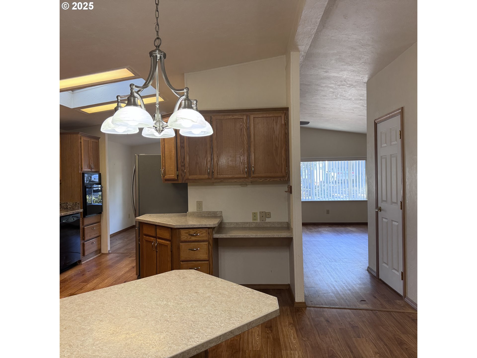 1601 Rhododendron Drive, Unit 695 Florence, OR 97439 - Photo 21 of 42 a kitchen with kitchen island stainless steel appliances a table and chairs in it