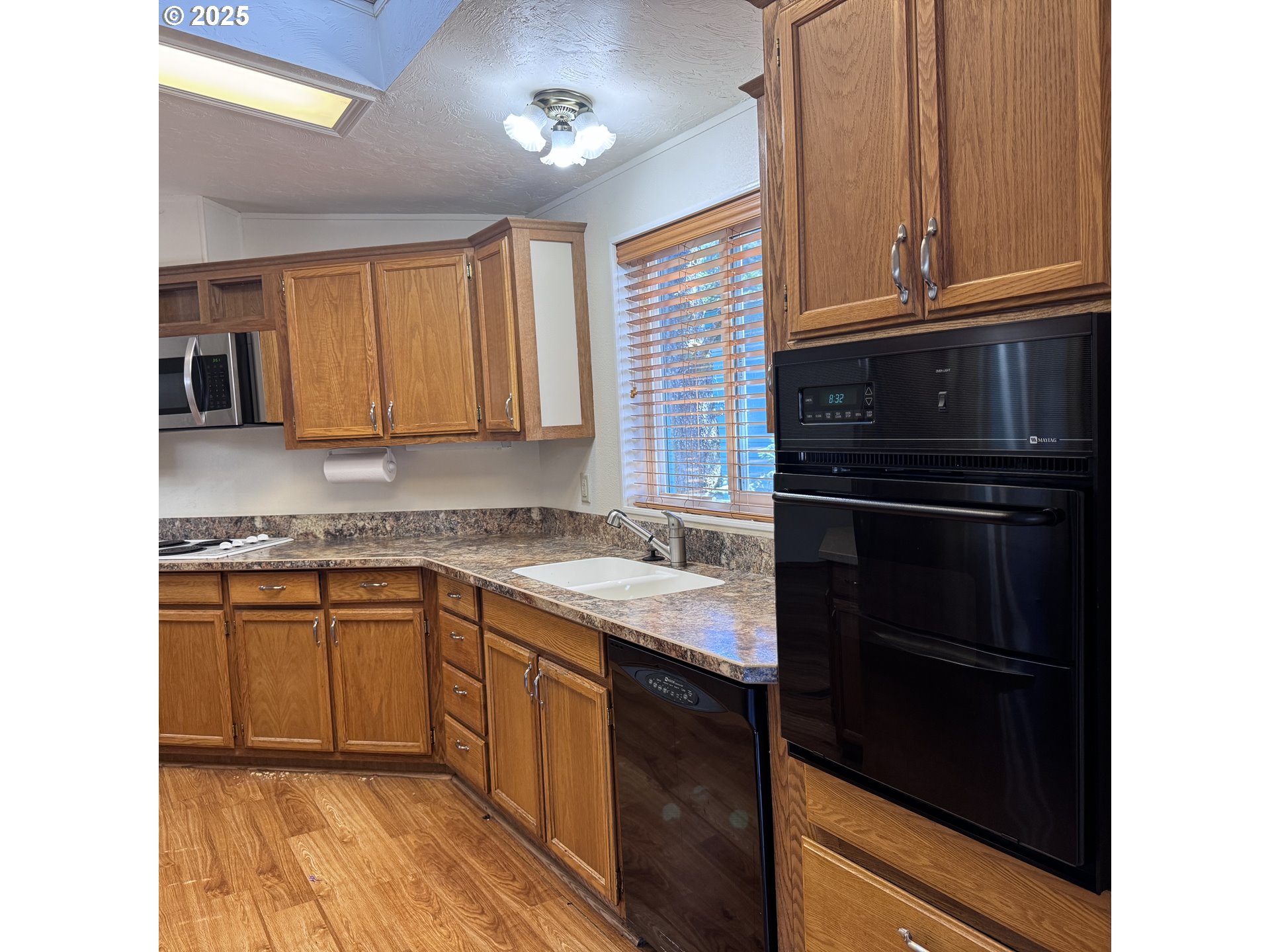 1601 Rhododendron Drive, Unit 695 Florence, OR 97439 - Photo 24 of 42 a kitchen with a sink stove and cabinets