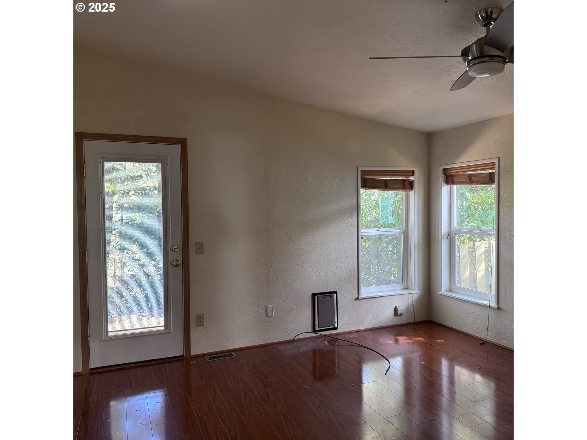 1601 Rhododendron Drive, Unit 695 Florence, OR 97439 - Photo 31 of 42 a view of an empty room with wooden floor and a window