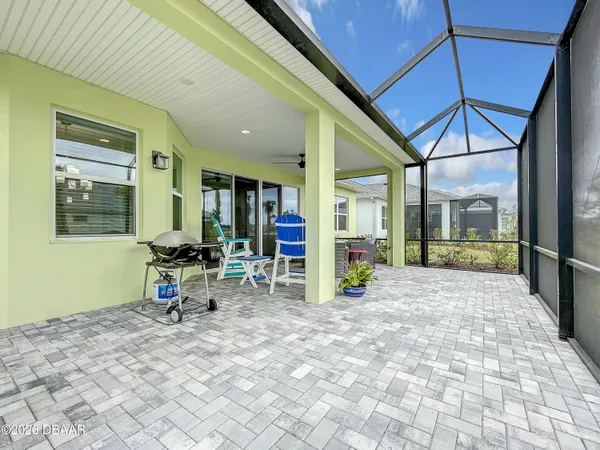a view of a patio with a table and chairs under an umbrella