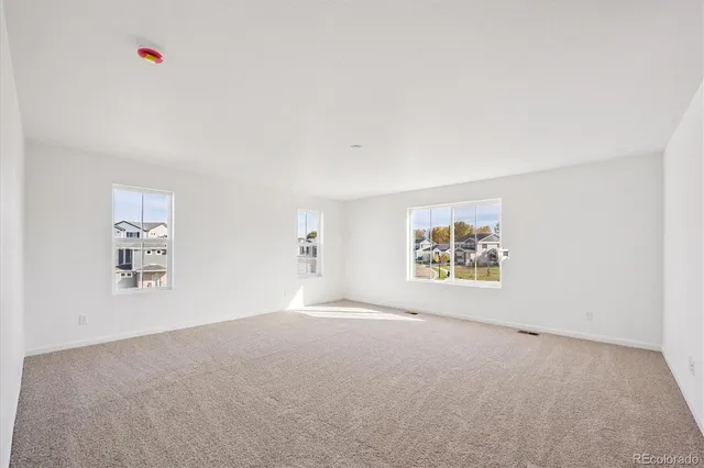 an empty room with windows and closet