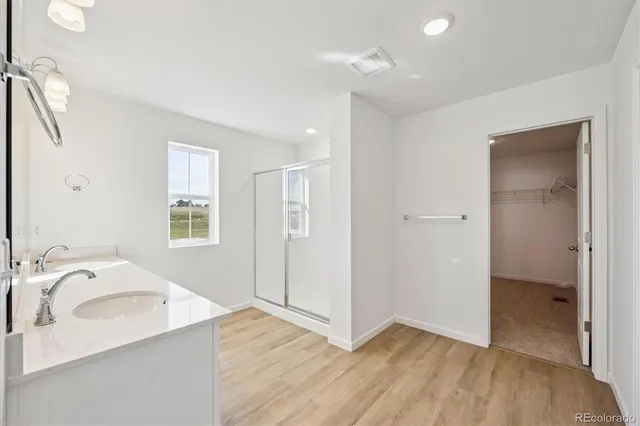 a view of a kitchen cabinets a sink and wooden floor