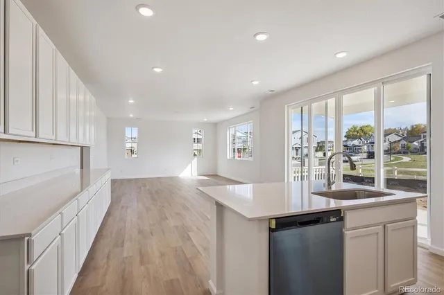 a kitchen with counter top space and wooden floor