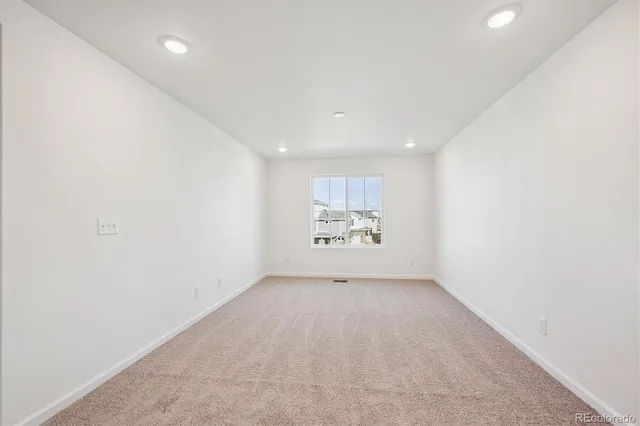 an empty room with a refrigerator