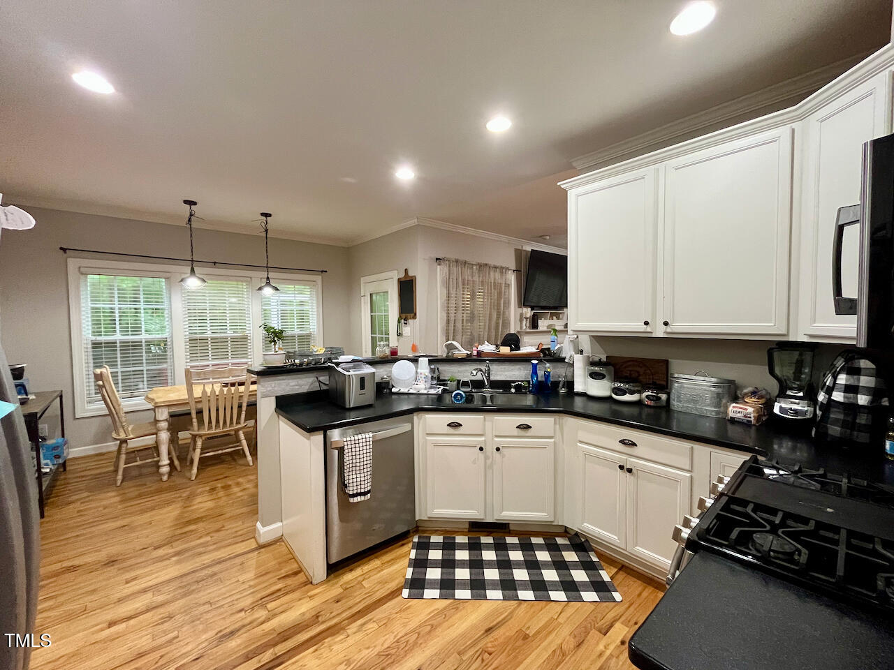 159 Geranium Way Clayton, NC 27527 - Photo 5 of 29 a kitchen with a sink stove and cabinets