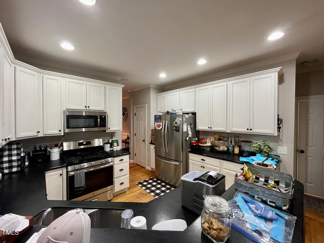 159 Geranium Way Clayton, NC 27527 - Photo 6 of 29 a kitchen with stainless steel appliances granite countertop a refrigerator stove top oven a sink and dishwasher