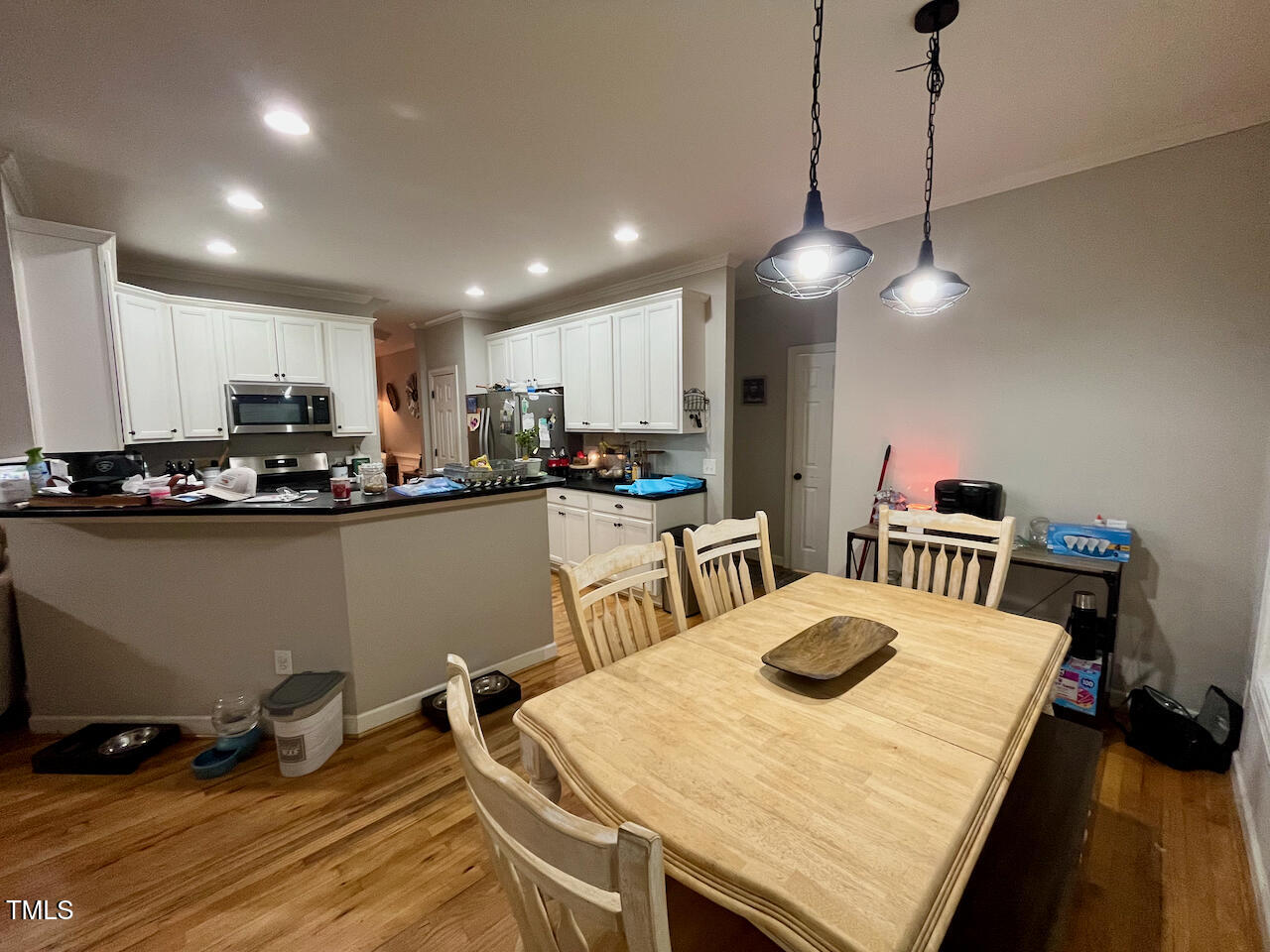 159 Geranium Way Clayton, NC 27527 - Photo 8 of 29 a kitchen with kitchen island a stove a table and chairs