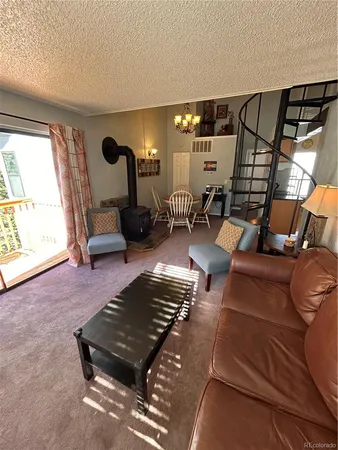 a living room with lots of furniture and a lamp