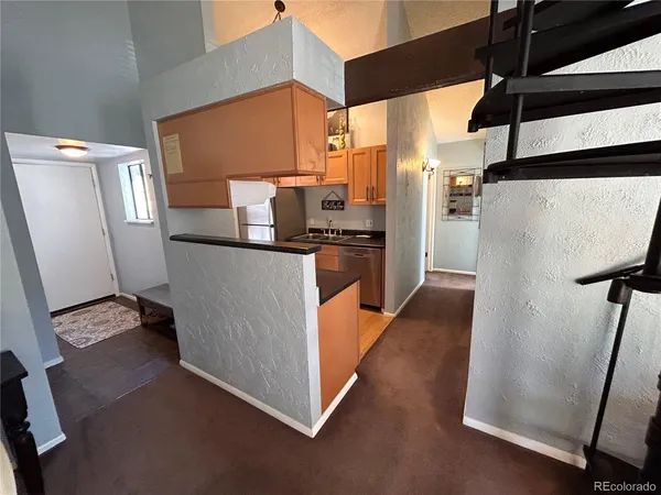 a kitchen with stainless steel appliances a refrigerator and a stove
