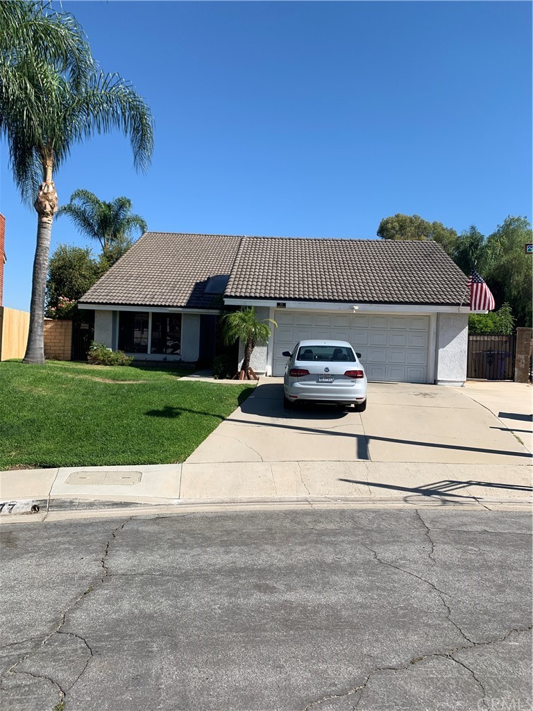 77 Rising Hill Road Pomona, CA 91766 - Photo 1 of 1 a front view of a house with a yard and garage