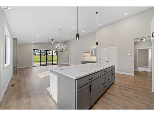 a kitchen with a stove and a wooden floor