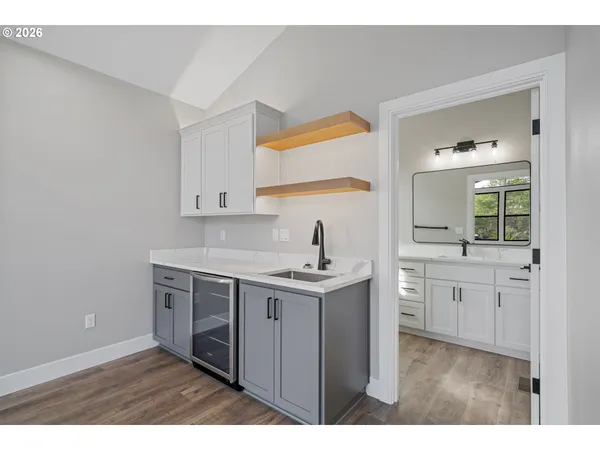 a kitchen with a sink cabinets and wooden floor