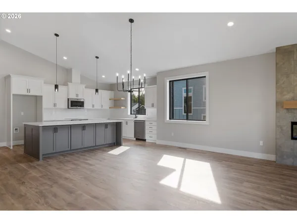 a large white kitchen with a large window