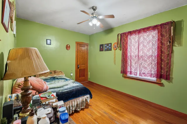 a bedroom with a bed and a painting on the wall