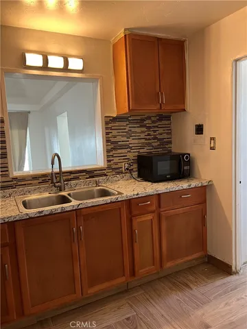 a kitchen with stainless steel appliances granite countertop a sink and cabinets