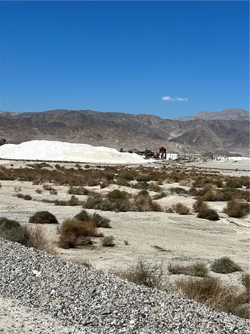 a view of wooden bench in the middle of a yard