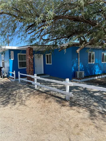 a house with trees in the background
